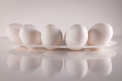 Eggs in a dish with reflection from surface