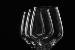 Three wine glasses on black bandground